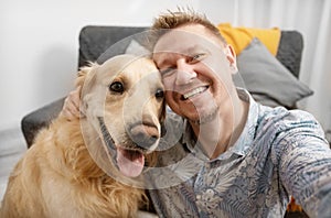 man with cute golden retriever dog