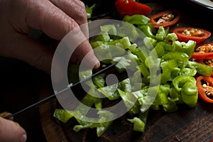 Man cuts green pepper for fajita close-up