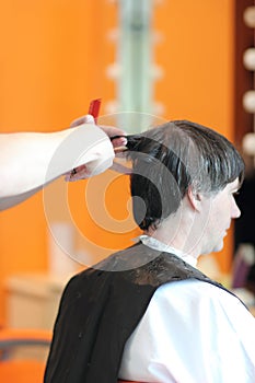 A man cuts hair in a barbershop