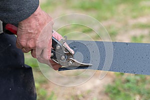 A man cuts a metal sheet with metal shears.