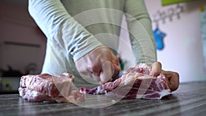 Man Cuts Pork Meat With Knife In Home Kitchen. Man's Hand Holds a Knife. Chef Cutting Meat. Home Cooking Food, Pork Meat