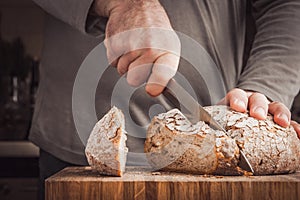 Man cutting bread