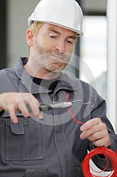 Man cutting cable