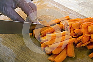 Man cutting carrot on table