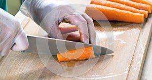 Man cutting carrot on table