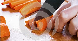 Man cutting carrot on table