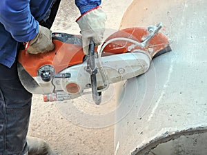 Man cutting concrete pipe