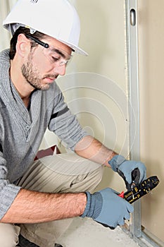 Man cutting electrical wire