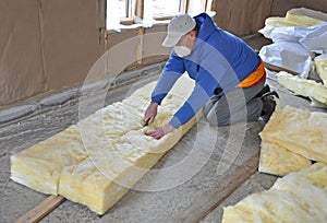 Man cutting fiberglass insulation photo