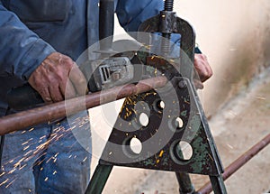 Man cutting a gas pipe for central gas installation