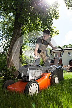 Man cutting grass in his yard