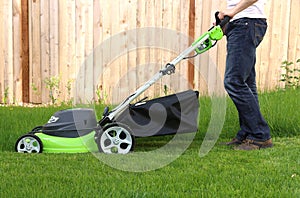 Man cutting the grass with lawn mower