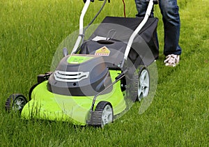 Man cutting the grass with lawn mower