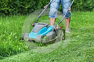 Man cutting the grass with a lawn mower