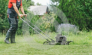 Man cutting grass with lawnmower