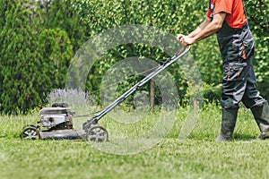 Man cutting grass with lawnmower