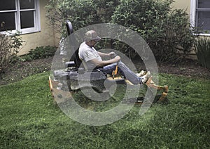 Man cutting grass on lawnmower