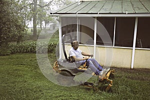 Man cutting grass on lawnmower