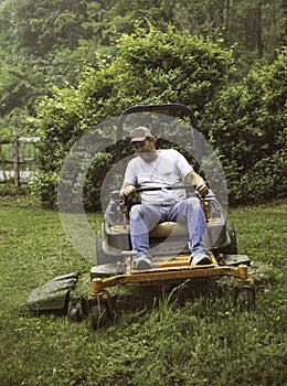 Man cutting grass on lawnmower