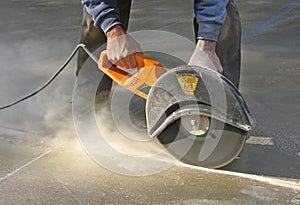 Man cutting groove in concrete slab