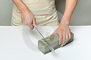 Man cutting a handmade soap with a knife