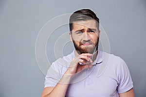 Man cutting his beard with scissors