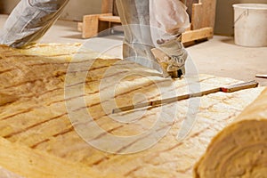 Man cutting insulation material for building photo