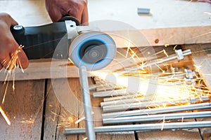 Man cutting iron by grinder