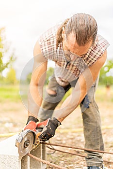 Man cutting iron using a radial saw