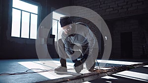 Man cutting metal with angle grinder