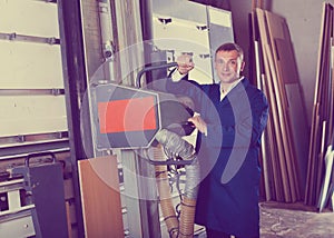 Man cutting plywood with electric saw