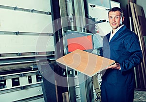 Man cutting plywood with electric saw