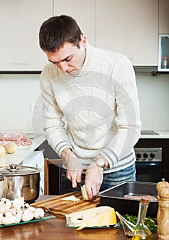 Man cutting potato at kitchen