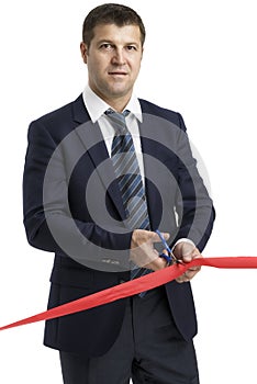 A man cutting a red ribbon, opening ceremony