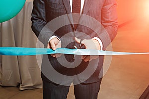 A man cutting a red ribbon, opening ceremony, isolated on white background