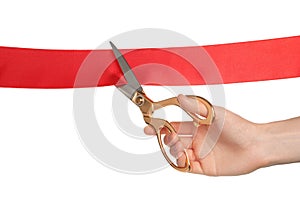 Man cutting red ribbon on white background, closeup