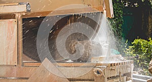 Man cutting a stone with a water saw