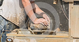 Man cutting a stone with a water saw