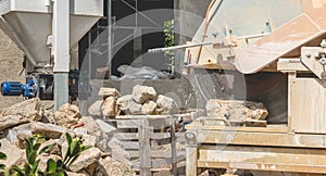 Man cutting a stone with a water saw