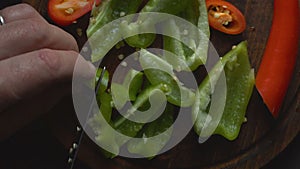 Man is cutting a sweet pepper for a fajita close-up. Video