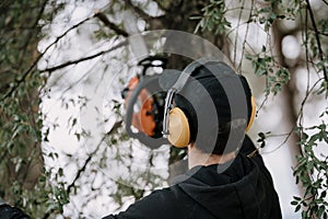 Man cutting a tree with a circular saw