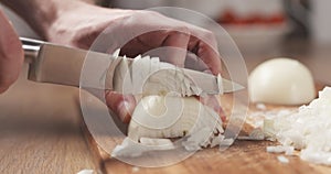 Man cutting white onion with knife