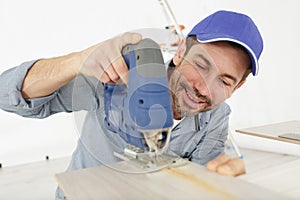 man cutting wood