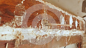 Man cutting wood brick with electric jigsaw. Worker cutting wood with hand saw