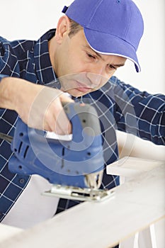 man cutting wood with milling machines closedup