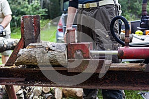 Man cutting wood outdoors with electric saw