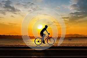 Man cycling at beach evening time
