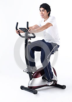 A man cycling bicycle in a gym