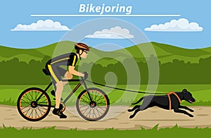 Man cycling bikejoring with his dog outside