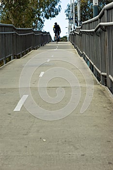 Man cycling on bridge overpass